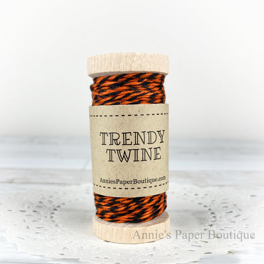 Orange Licorice Trendy Twine. Orange and black twine on a wooden spool.